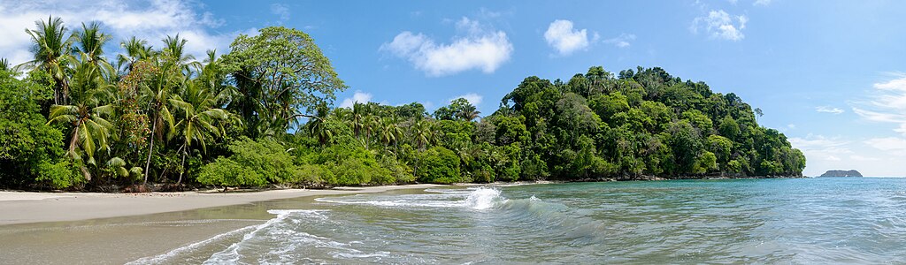 Manuel Antonio beach with lush jungle cliffs and turquoise waters